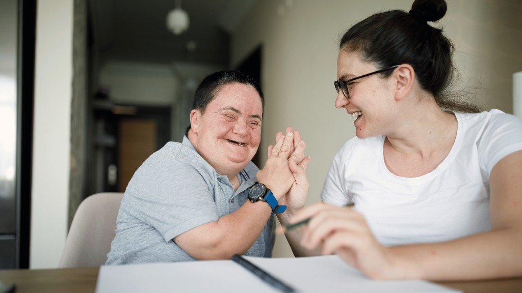 Support worker and participant sharing a laugh during a home visit in Darwin