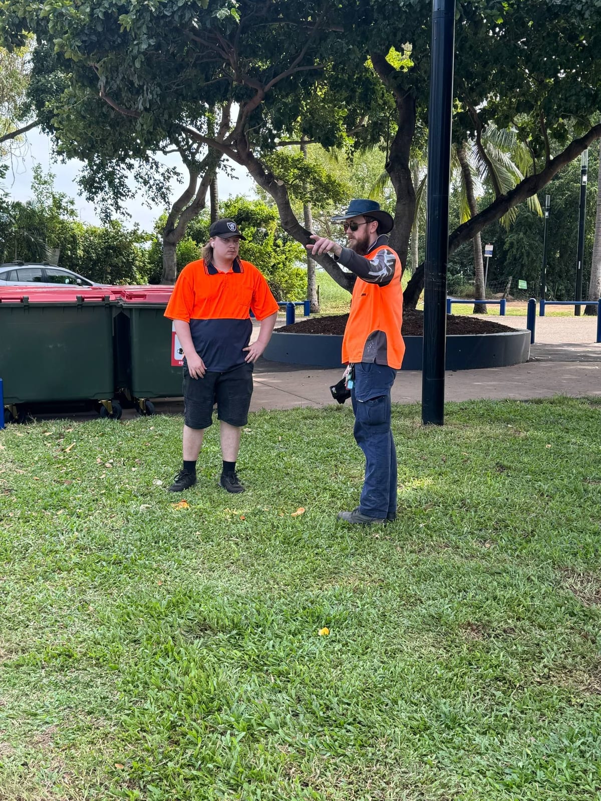 Participants working together on grounds tidy-up at a Darwin park