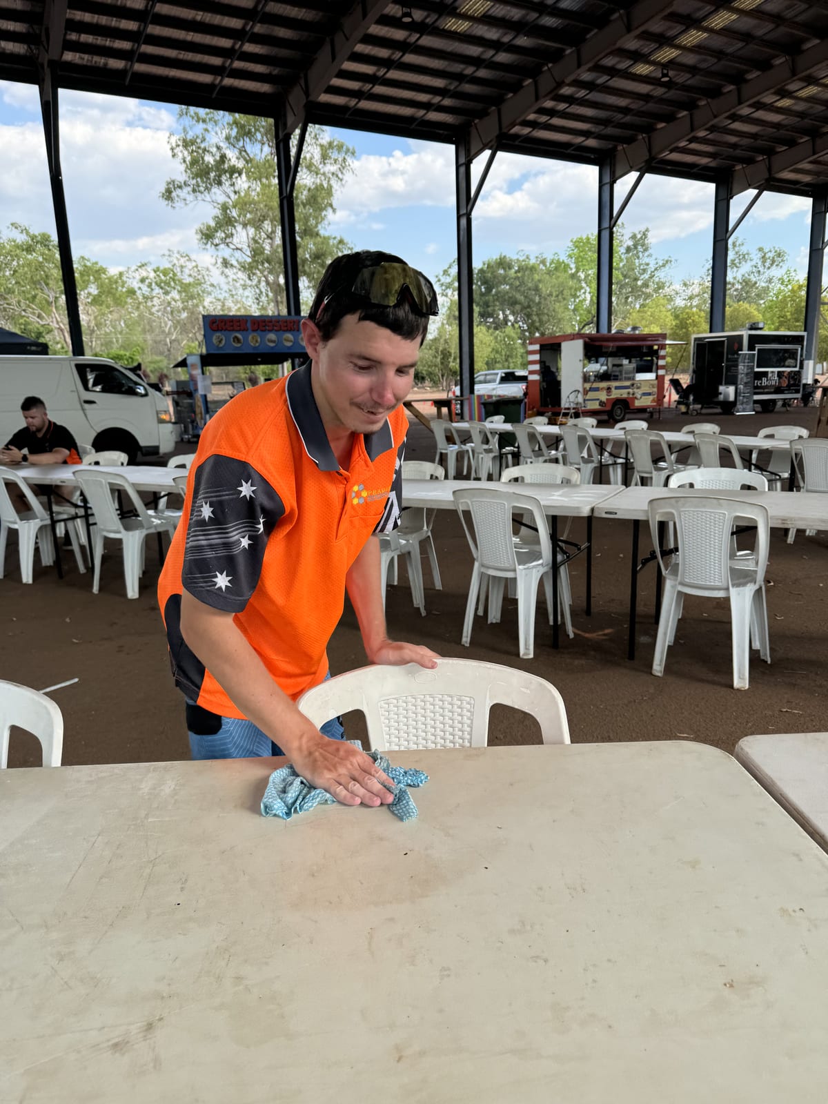 Participant wiping down a table while building everyday household routines