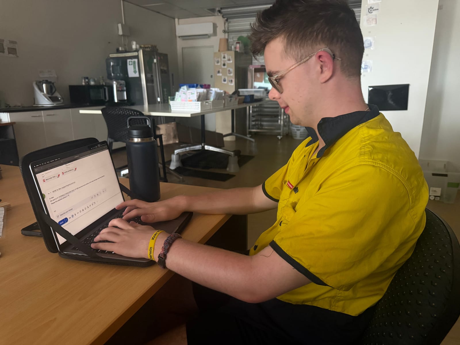 Participant building workplace skills at a desk with a laptop