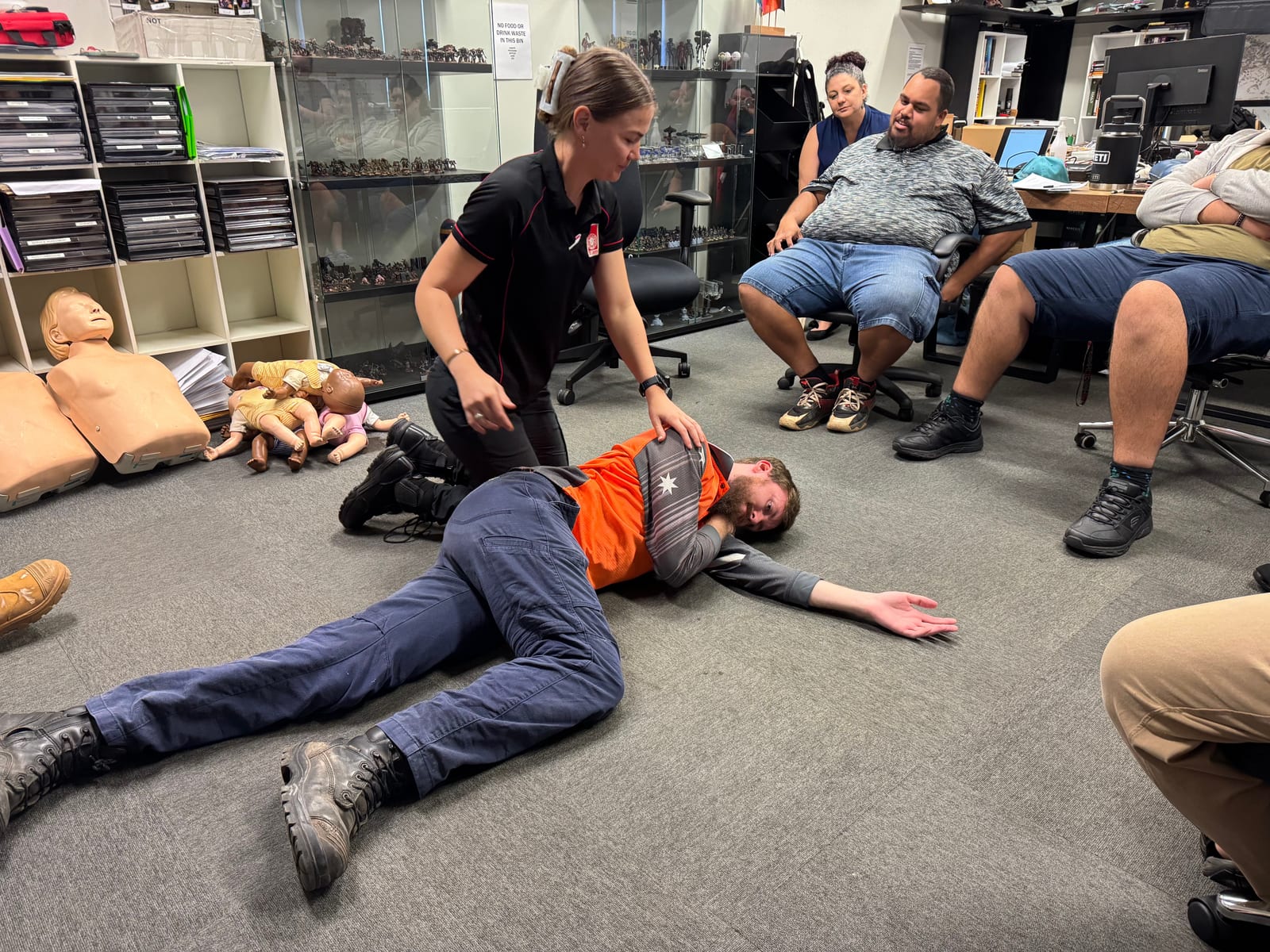 Group first aid training demonstrating the recovery position