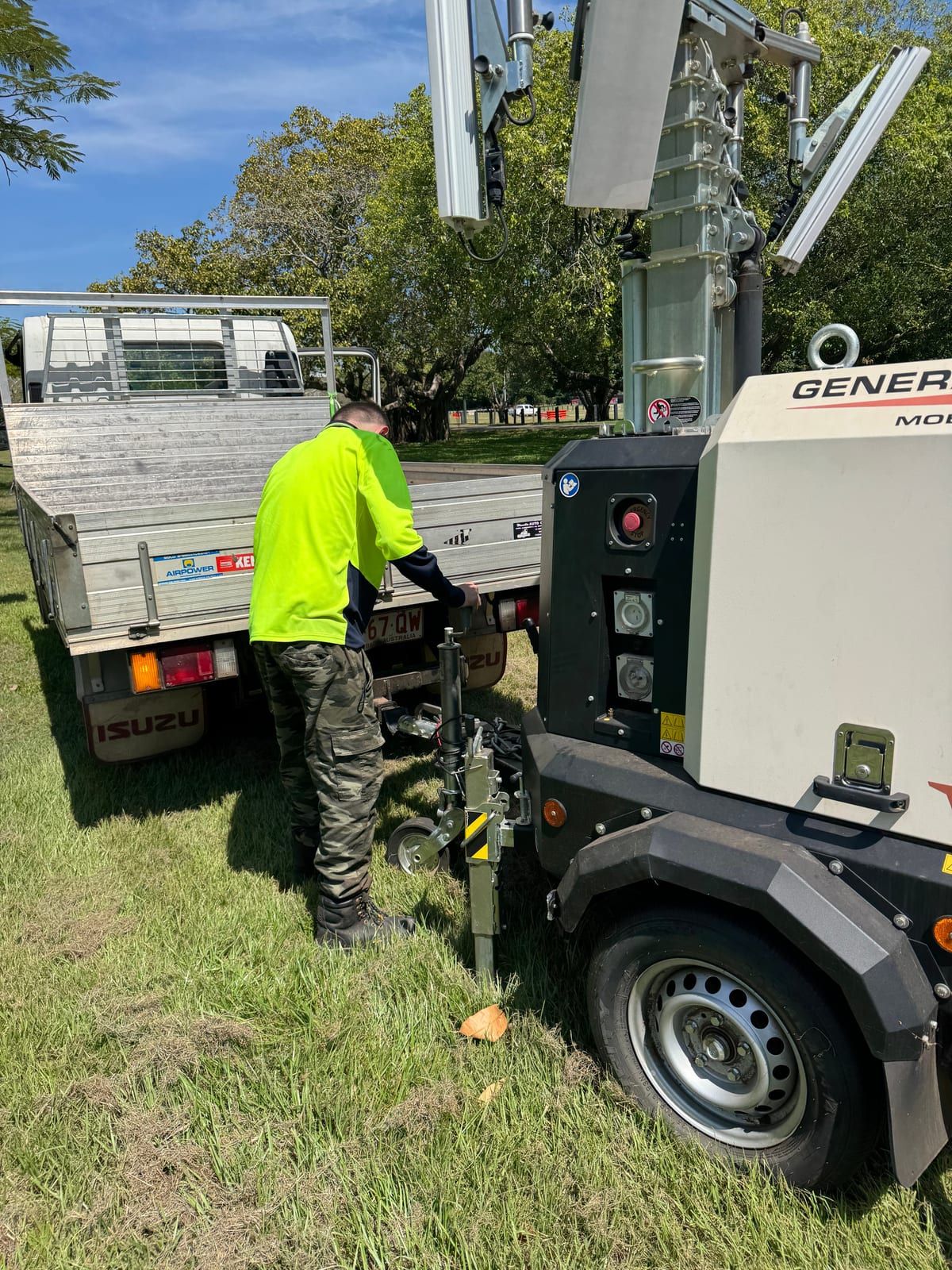 Participant loading a lighting generator onto a truck for an event set-up