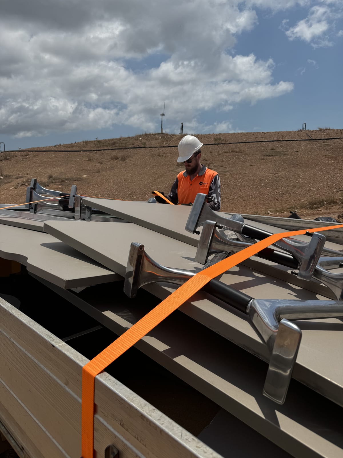 Participant working on a roof installation on a supported work site in the NT