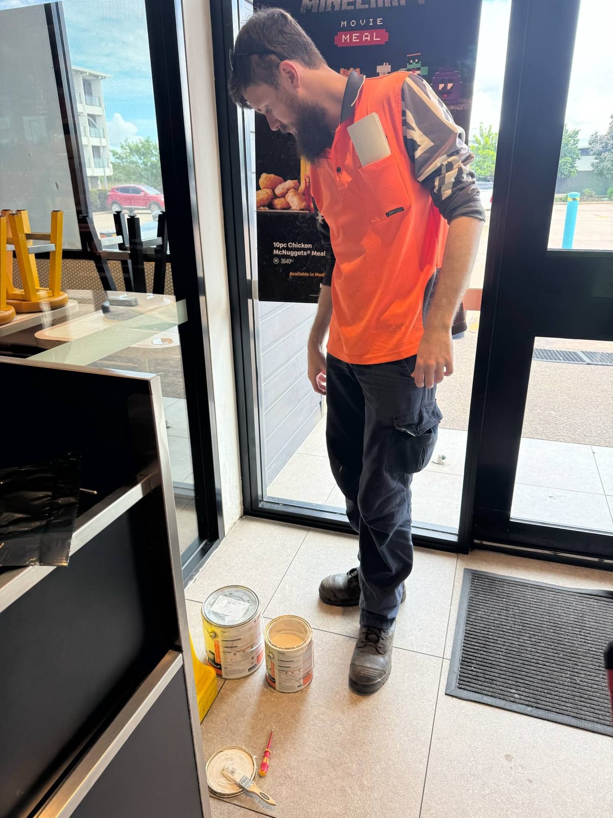 Participant carrying out supported work at a local Darwin shopfront
