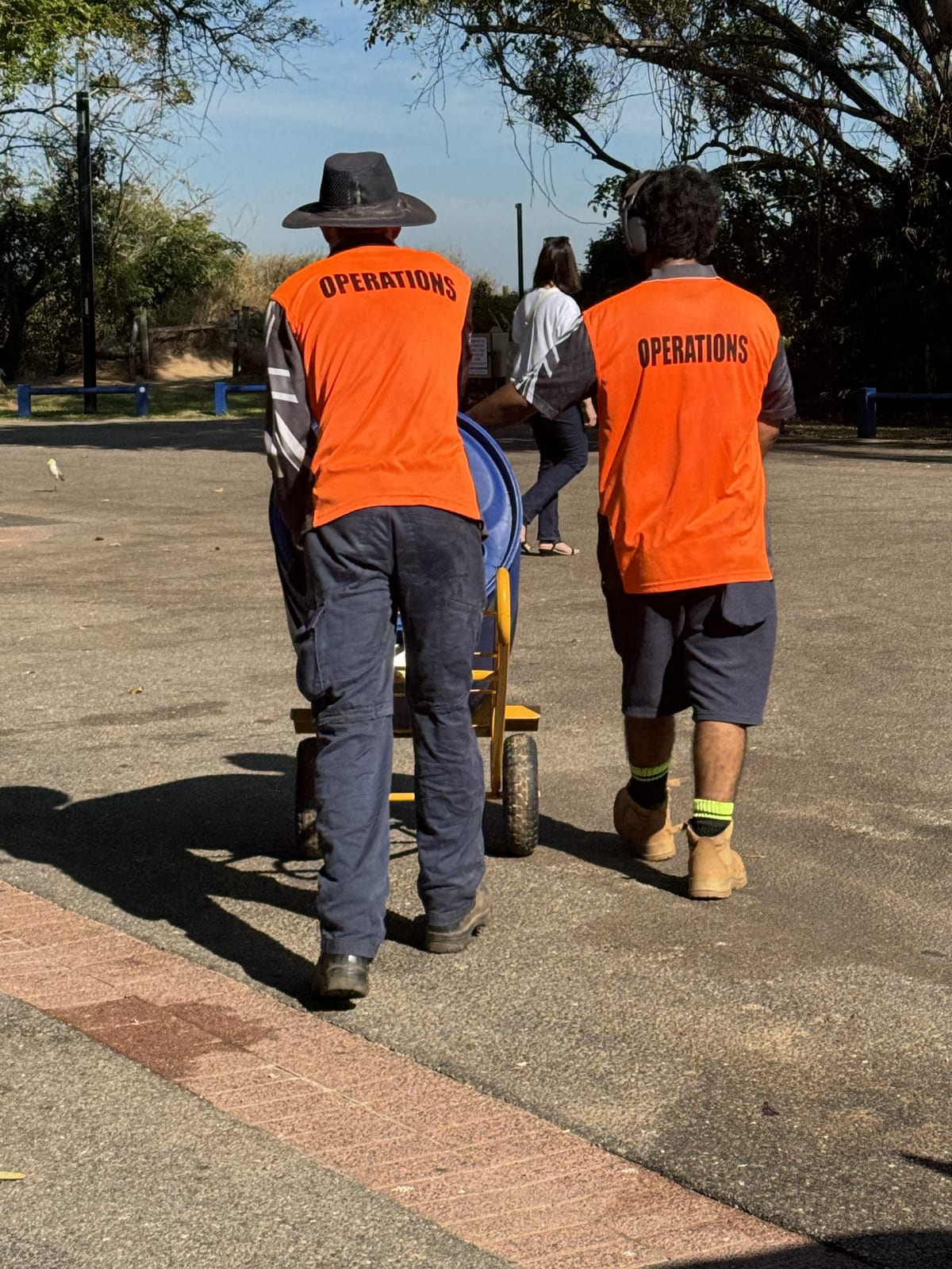 Two participants moving equipment together on a supported work shift