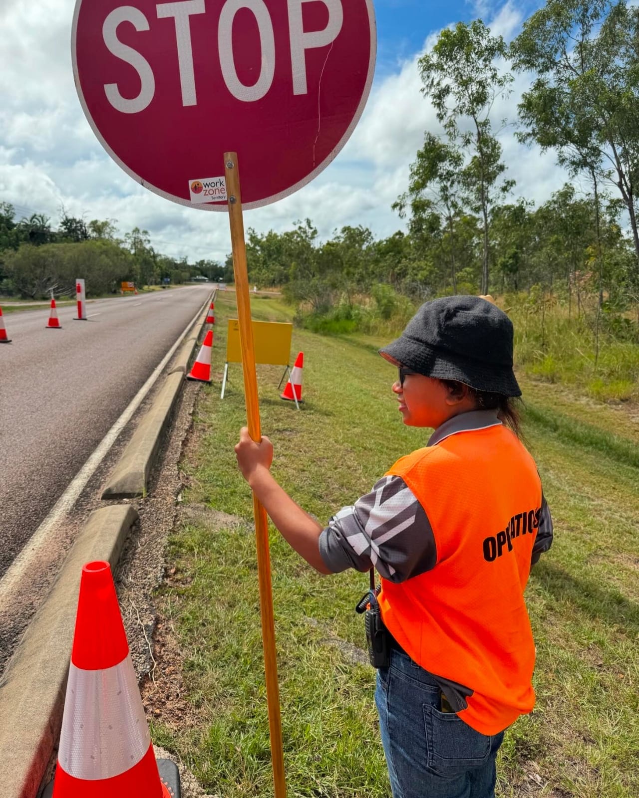 Participant on roadside traffic control during supported work